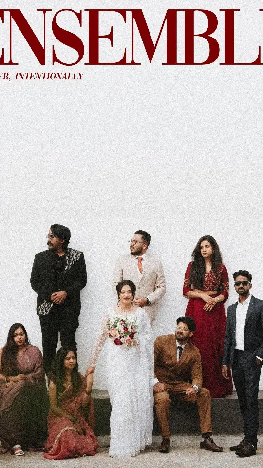 Abhijith & Chinnu: bridal party portrait with the couple seated at the centre of the group