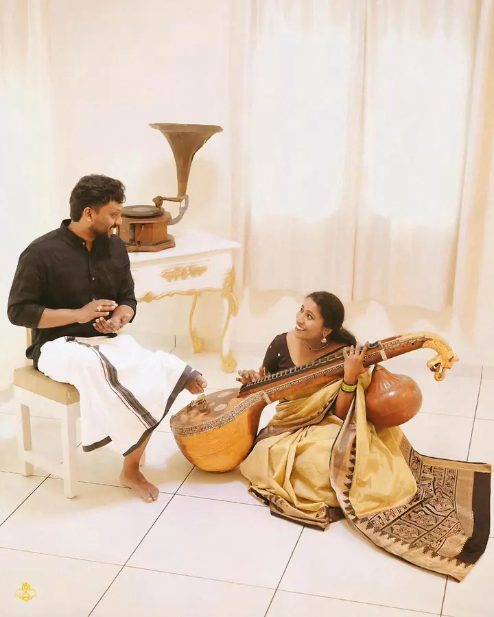 Portrait session with a veena and gramophone in a white, curtained room