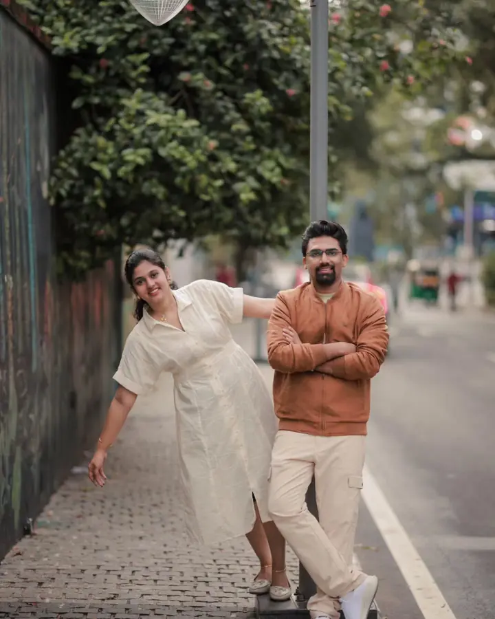 Couple on a narrow street, laughing, in an easy pre-wedding portrait