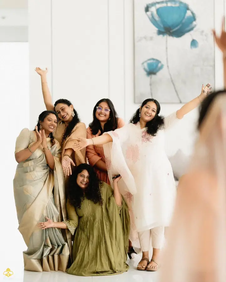 Bridesmaids cheering together while the bride gets ready
